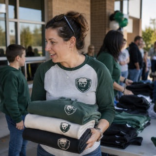 PTA volunteer with folded school spirit wear