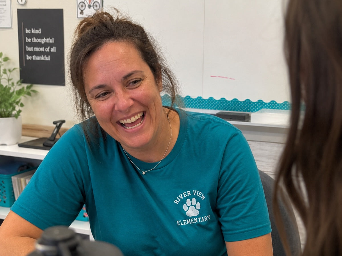 Teacher in custom branded school apparel