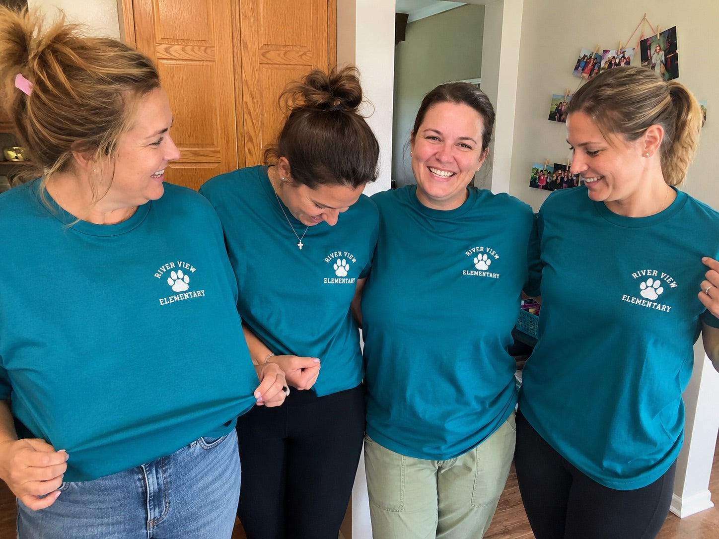 A group of friends laughing together in their matching custom school shirts