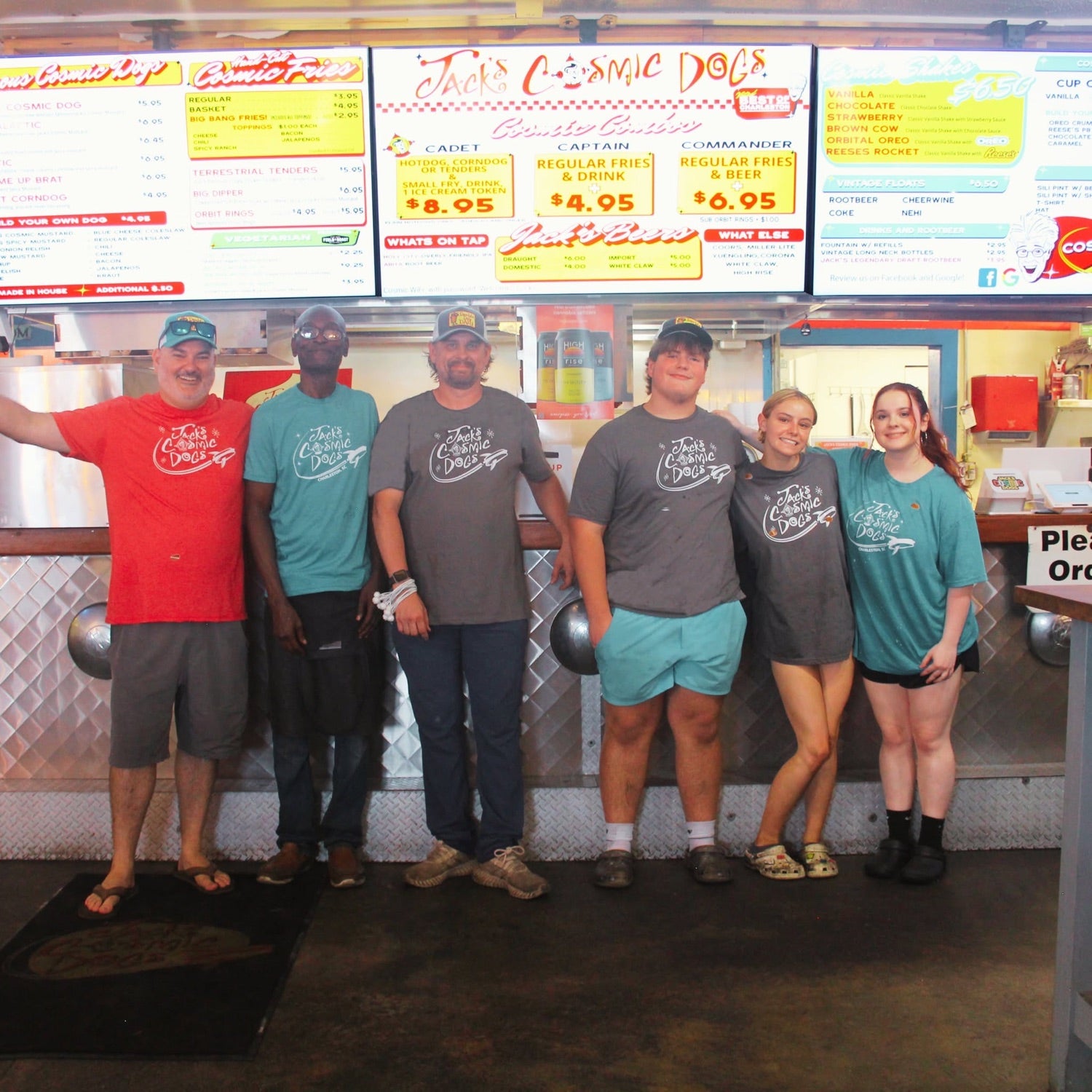Business team wearing matching branded shirts at their workplace