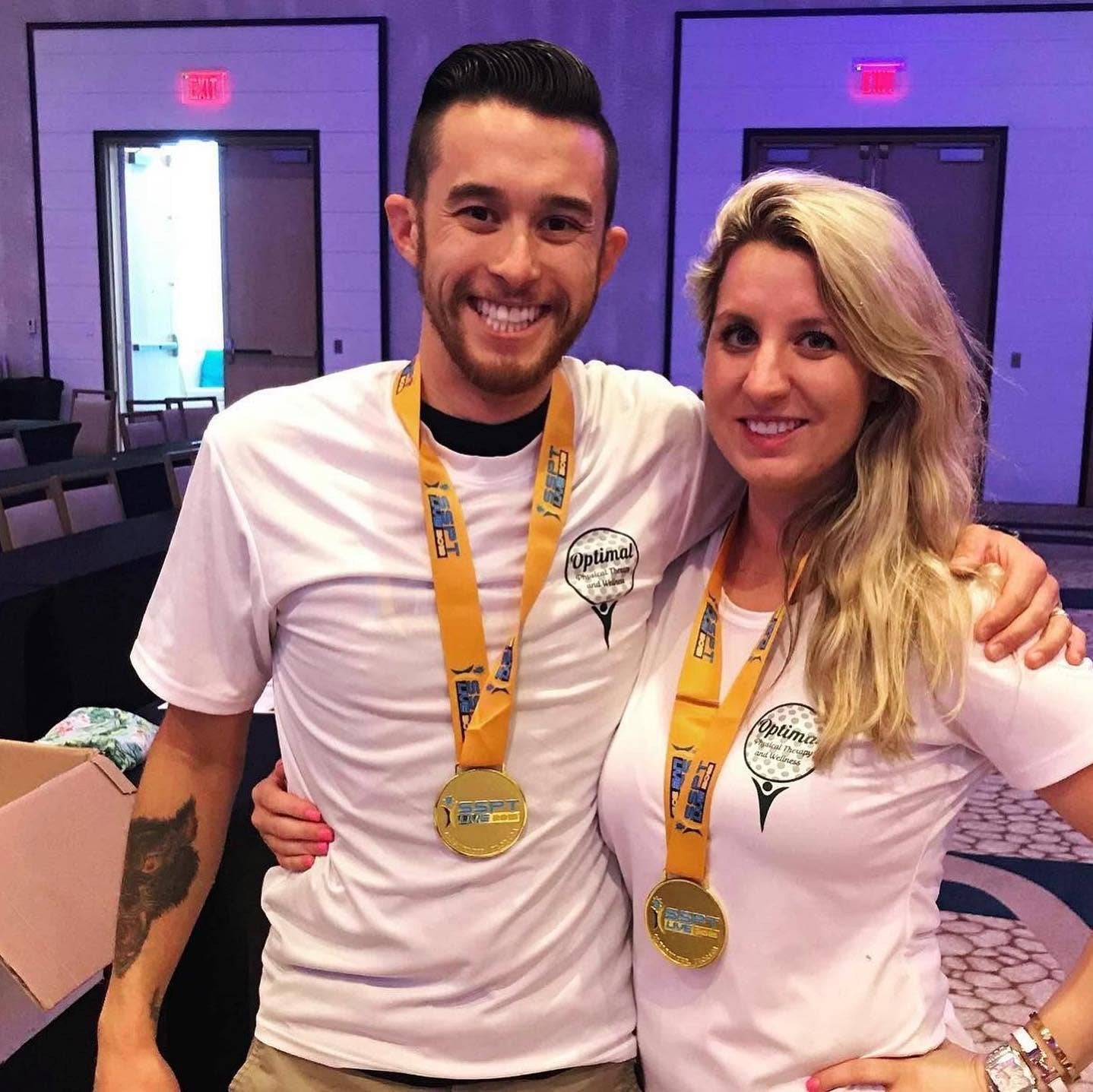Event attendees in matching custom tees with medals