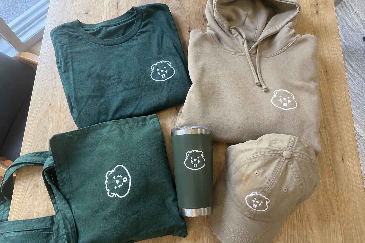 Custom printed apparel and gear laid out flat, ready for a store launch