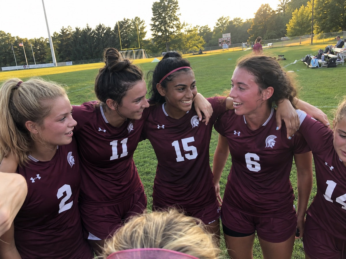 School sports team in custom jerseys with numbers